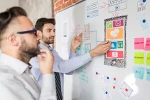 Designers drawing website ux app development.
