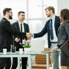 handshake of business partners after signing the contract in the workplace in a modern office