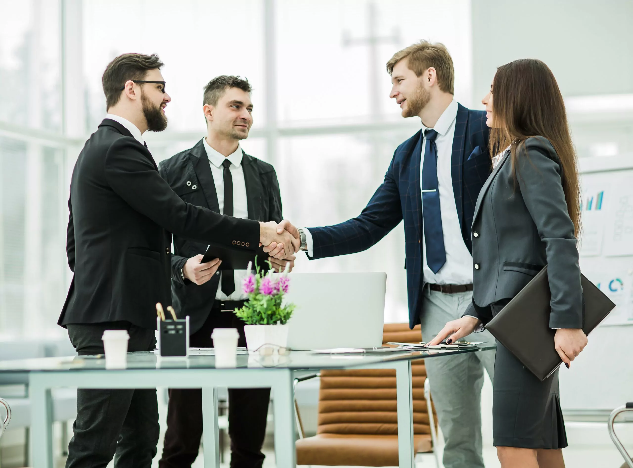 handshake of business partners after signing the contract in the workplace in a modern office